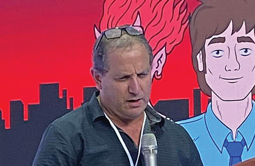  DAVID M. STERN in front of an image from ‘Ugly Americans.’  (credit: EINAT KAPACH)