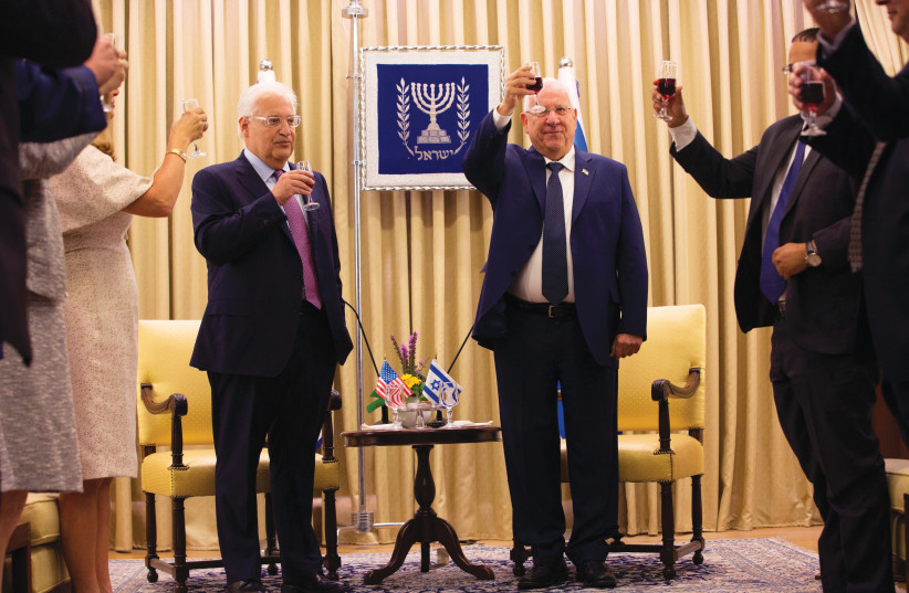 US AMBASSADOR David Friedman (L) toasts with president Reuven Rivlin (C-R) during a credentials presentation ceremony in Jerusalem, 2017.  (credit: Heidi Levine/AFP via Getty Images)