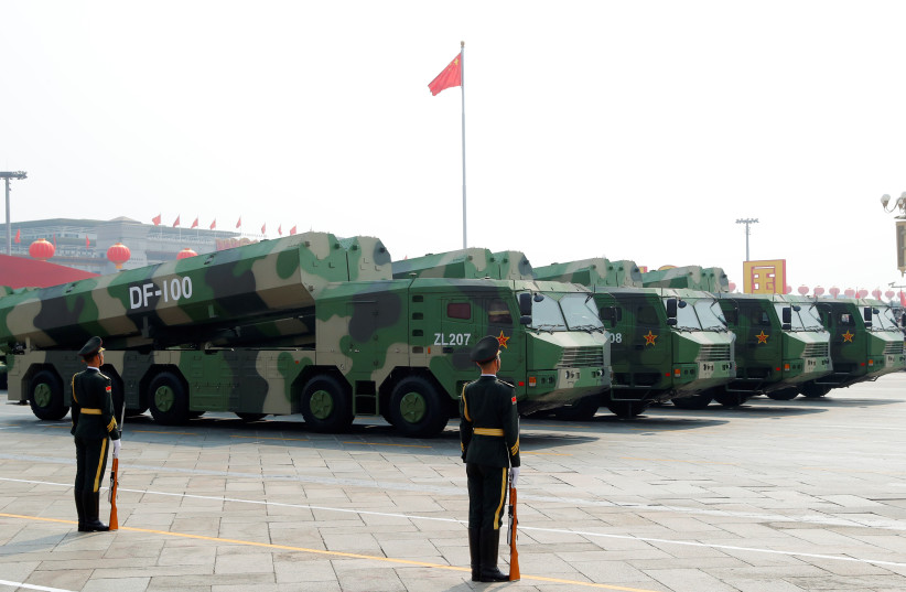 Military vehicles carrying hypersonic cruise missiles DF-100 drive past Tiananmen Square during the 70th founding anniversary of People's Republic of China in Beijing (photo credit: REUTERS)