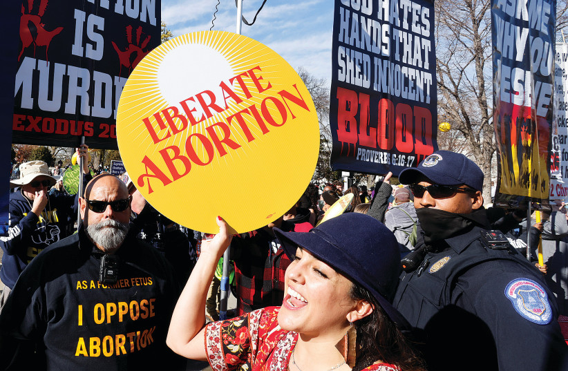 A PRO-ABORTION activist protests in front of anti-abortion activits outside the US Supreme Court building in Washington last year. (photo credit: JONATHAN ERNST/REUTERS)