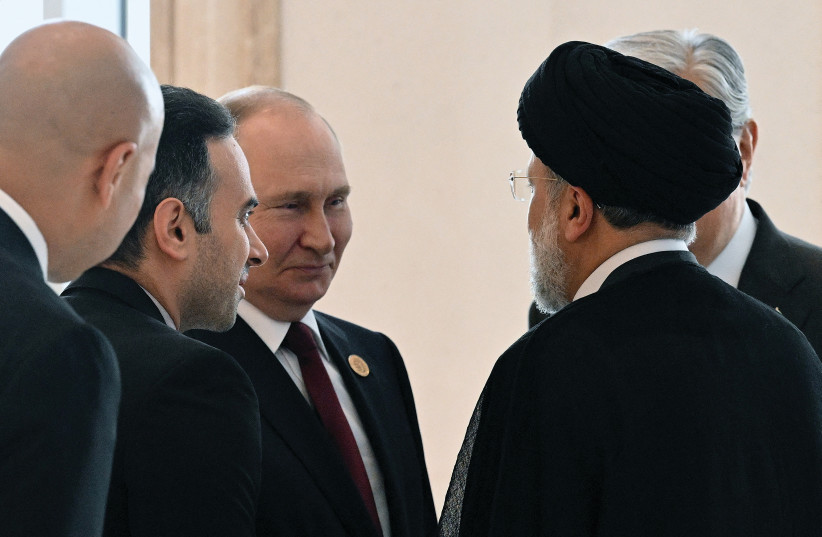  RUSSIAN PRESIDENT Vladimir Putin and Iranian President Ebrahim Raisi speak at the Caspian Summit in Ashgabat, Turkmenistan, on Wednesday.  (photo credit: SPUTNIK/GRIGORY SYSOYEV/REUTERS)
