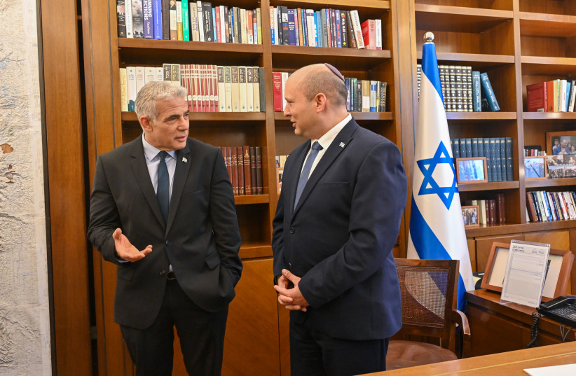  Outgoing Prime Minister Naftali Bennett and incoming Prime Minister Yair Lapid, June 30, 2022.  (photo credit: KOBI GIDEON/GPO)