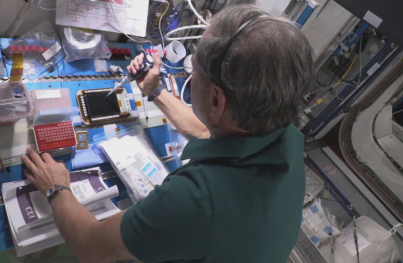 Eytan Stibbe performing the experiment on the International Space Station. (photo credit: ISRAEL SPACE AGENCY, RAMON FOUNDATION)