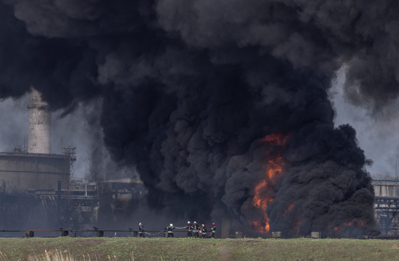  Firefighters work to put out a fire at Lysychansk Oil Refinery after if was hit by a missile at Lysychansk, Luhansk Oblast, Ukraine, April 16, 2022. (credit: MARKO DJURICA/REUTERS)