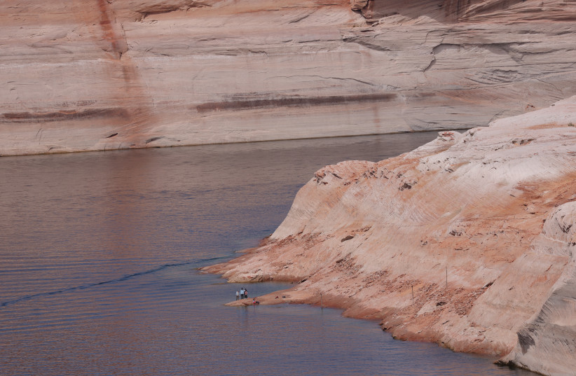 Lake Powell, where exposed rock bleached by years of being submerged illustrates how far water levels have declined to lows not seen since the reservoir was filled in the 1960s, in Page, Arizona, US, April 18, 2022 (credit: REUTERS/CAITLIN OCHS)