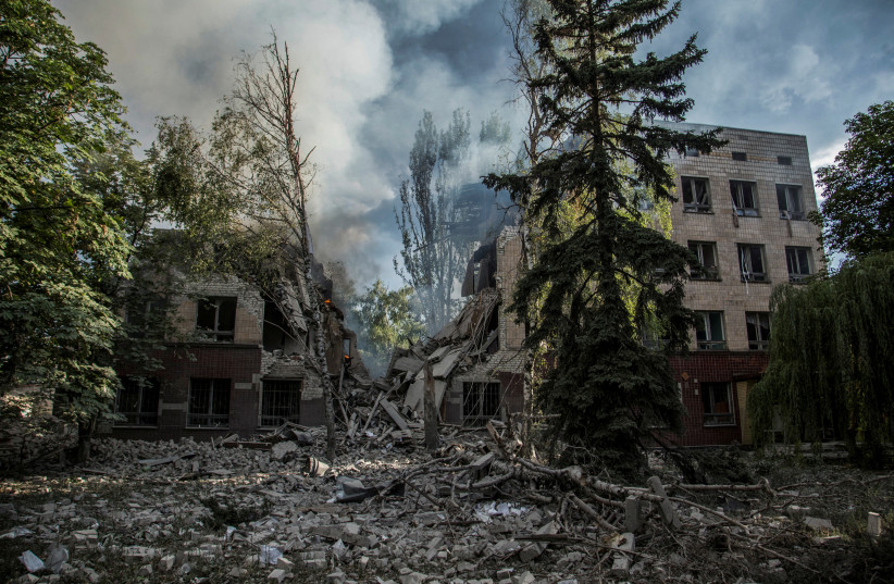 Smoke rises over the remains of a building destroyed by a military strike, as Russia's attack on Ukraine continues, in Lysychansk, Luhansk region, Ukraine, June 17, 2022. (photo credit: REUTERS/OLEKSANDR RATUSHNIAK/FILE PHOTO)