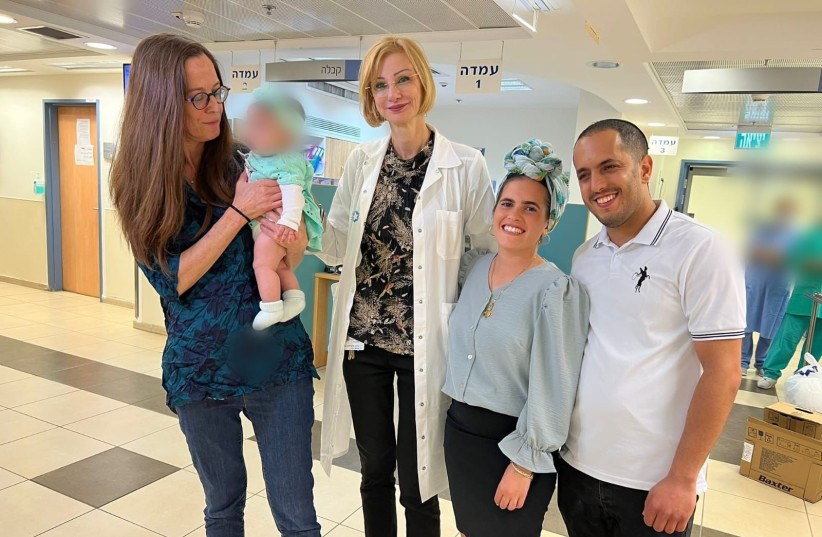  From left – Dr. Revital Arbel holding the baby, Prof. Gheona Altarescu and the parents, Yafit and Haim Yifrah. (photo credit: SHAARE ZEDEK MEDICAL CENTER)