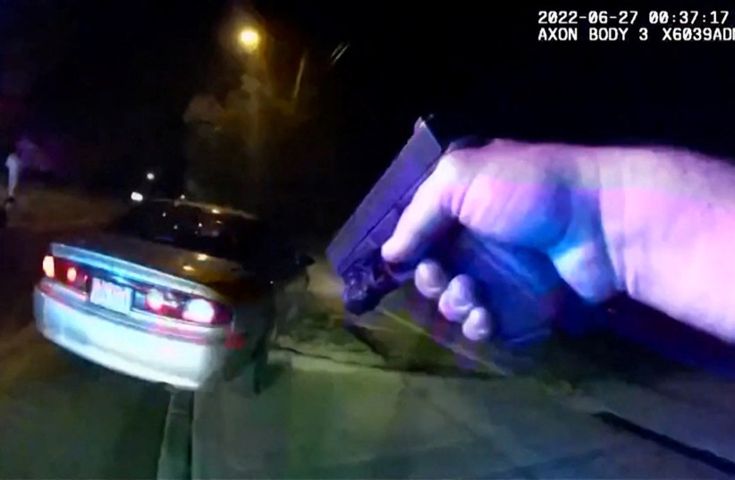  An Akron Police officer runs towards the vehicle of Black man Jayland Walker just before he exited and ran from the car and was then shot to death by up to eight officers, in Akron, Ohio, US, June 25, 2022 in a still image from police body camera video.  (credit: CITY OF AKRON/HANDOUT VIA REUTERS)