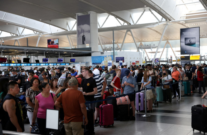 Passengers wait to check in at John F. Kennedy International Airport on the July 4th holiday weekend in Queens, New York City, US, July 2, 2022. (photo credit: REUTERS/ANDREW KELLY TPX IMAGES OF THE DAY)