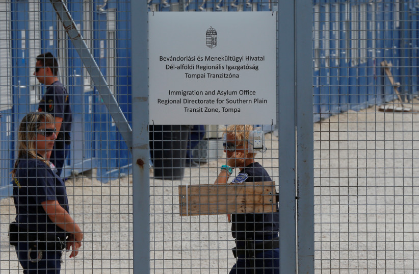  Security guards stand by the gate of the transit zone, where migrants are hosted in container camps and their asylum claims are processed in Tompa, Hungary, June 14, 2017. (credit: LASZLO BALOGH/REUTERS)
