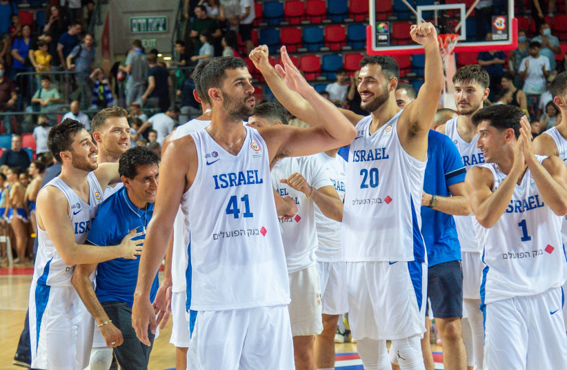ISRAEL TEAMMATES celebrate on the court at the Drive-In Arena in Tel Aviv after beating Estonia  96-77 to advance to the next round of FIBA World Cup qualifying. (photo credit: BERNEY ARDOV)
