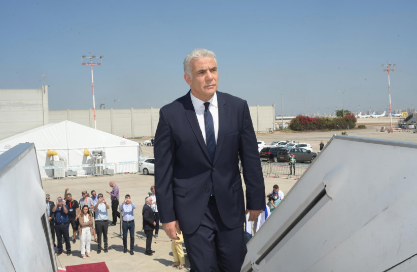 Prime Minister Yair Lapid boarding a flight to Paris, marking his first trip as Israel's prime minister, July 5, 2022 (credit: AMOS BEN-GERSHOM/GPO)