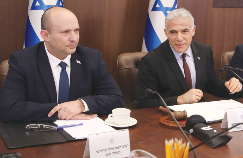  YAIR LAPID sits alongside Naftali Bennett at Sunday’s cabinet meeting. Lapid’s place card now says “prime minister” and Bennett’s says “alternate prime minister.” (photo credit: MARC ISRAEL SELLEM/THE JERUSALEM POST)