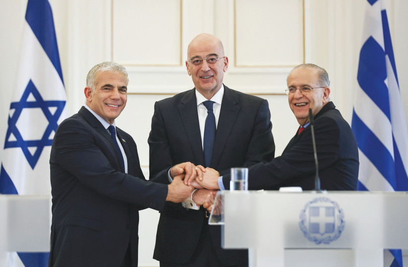  PRIME MINISTER Yair Lapid, as foreign minister, meets with Greek Foreign Minister Nikos Dendias (center) and Cypriot Foreign Minister Ioannis Kasoulidis in Athens, in April.  (photo credit: Louiza Vradi/Reuters)