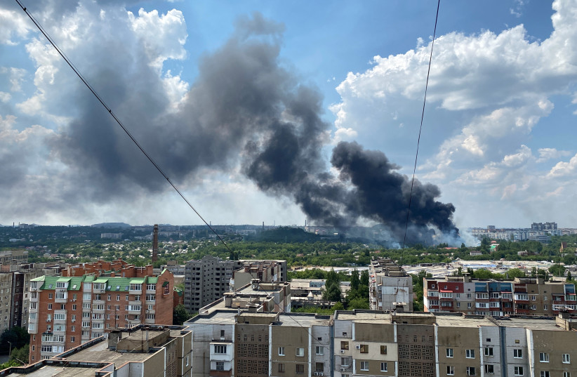 Smoke rises from the territory of an automotive centre following recent shelling during Ukraine-Russia conflict in Donetsk, Ukraine July 5, 2022. (credit: REUTERS/Kazbek Basayev)