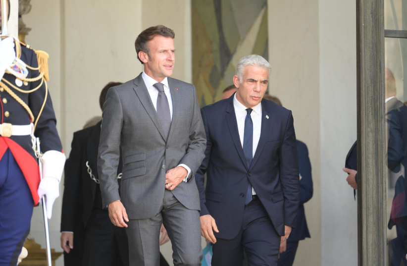 Prime Minister Yair Lapid meets with French President Emanuel Macron in Paris, July 5, 2022. (credit: AMOS BEN-GERSHOM/GPO)