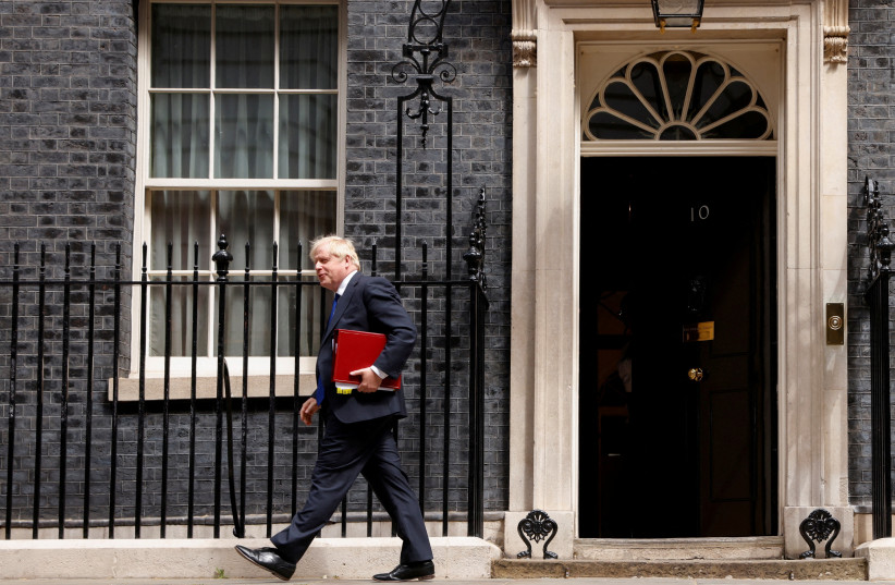  British Prime Minister Boris Johnson walks at Downing Street, in London, Britain. (credit: REUTERS/JOHN SIBLEY)