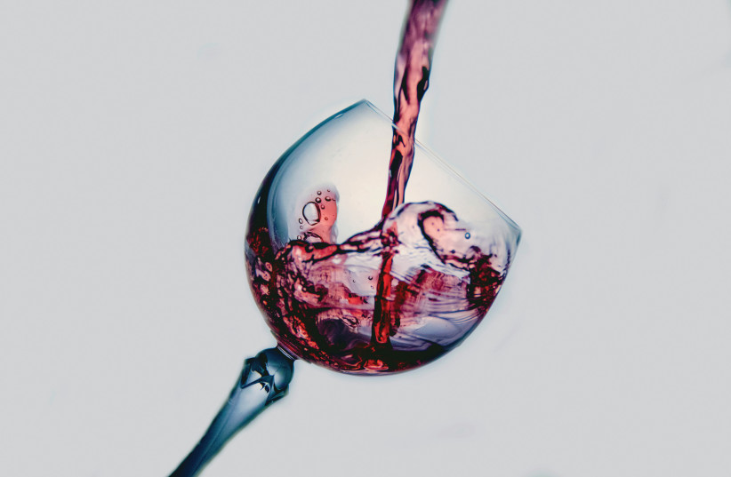  A glass of wine (Illustrative). (photo credit: Terry Vlisidis/Unsplash)