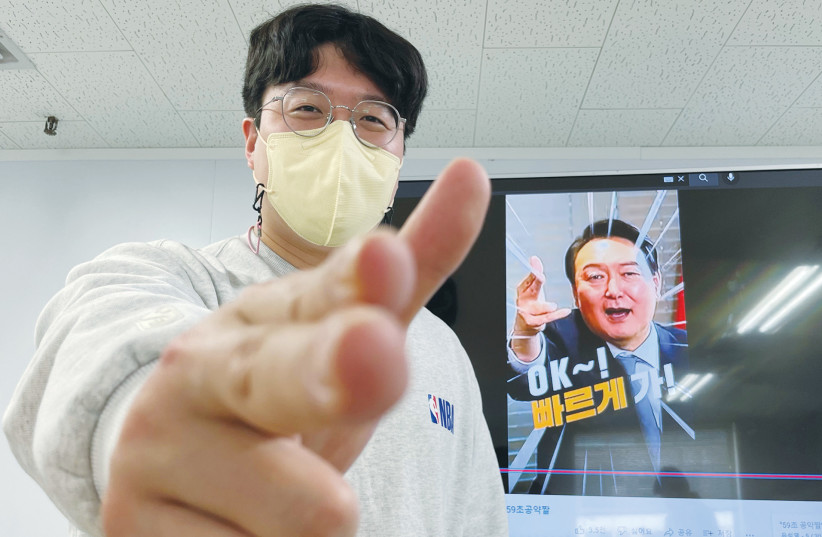  AN ADVISER for Yoon Suk-yeol during the presidential election campaign in South Korea  poses for photographs with a carefully created image of the candidate.  (photo credit: HYUN YOUNG YI / REUTERS)