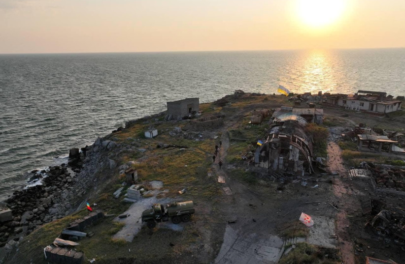  Ukrainian service members walk next to destroyed buildings, as Russia's attack on Ukraine continues, on Snake (Zmiinyi) Island, in Odesa region, Ukraine, in this handout picture released July 7, 2022. (credit: UKRAINIAN ARMED FORCES/HANDOUT VIA REUTERS)