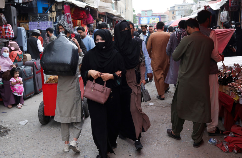  Afghan women walk at a market place in Kabul, Afghanistan, May 10, 2022.  (credit: REUTERS)