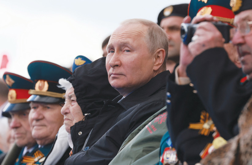  RUSSIAN PRESIDENT Vladimir Putin watches a military parade on Victory Day, in Red Square, in May. (photo credit: SPUTNIK/REUTERS)
