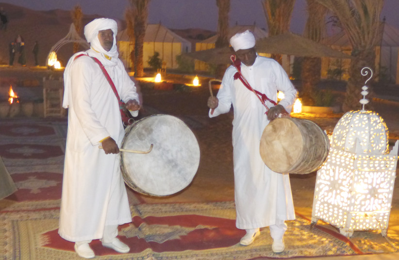  A GROUP OF Berber entertainers singing and drumming around a large bonfire at the Sahara Desert Luxury Camp. (photo credit: MANOS ANGELAKIS)
