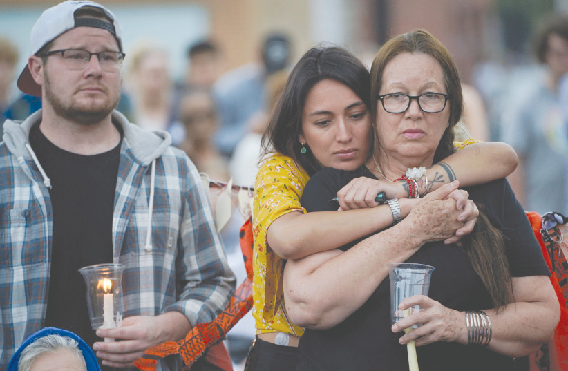  MOURNERS ATTEND a vigil after the mass shooting at a Fourth of July parade in the Chicago suburb of Highland Park. (credit: CHENEY ORR/REUTERS)