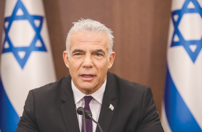  PRIME MINISTER Yair Lapid leads the weekly cabinet meeting at the Prime Minister’s Office in Jerusalem, on Sunday. ‘There is a list of target countries. Saudi Arabia is first among them,’ says Lapid, referring to expanding the Abraham Accords.  (photo credit: MARC ISRAEL SELLEM)