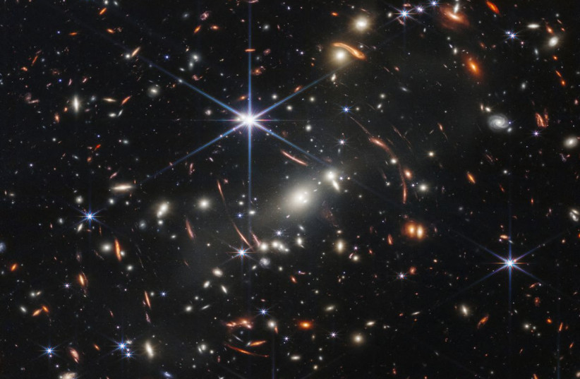  The first full-color image from NASA's James Webb Space Telescope, a revolutionary apparatus designed to peer through the cosmos to the dawn of the universe, shows the galaxy cluster SMACS 0723, known as Webb’s First Deep Field, in a composite made from images at different wavelengths.  (photo credit: NASA/HANDOUT VIA REUTERS)