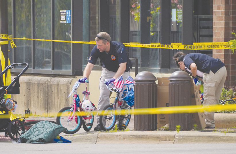  BICYCLES AND a stroller, among other abandoned personal belongings, are removed by FBI agents from the scene of the July 4 mass shooting in Highland Park, Illinois. (photo credit: CHENEY ORR/REUTERS)