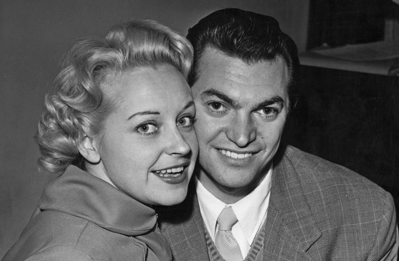  Composer Monty Norman (right) in London, with singer and actress Diana Coupland, after the couple announced their engagement, Nov. 26, 1955. (photo credit: Topical Press Agency/Hulton Archive/Getty Images)