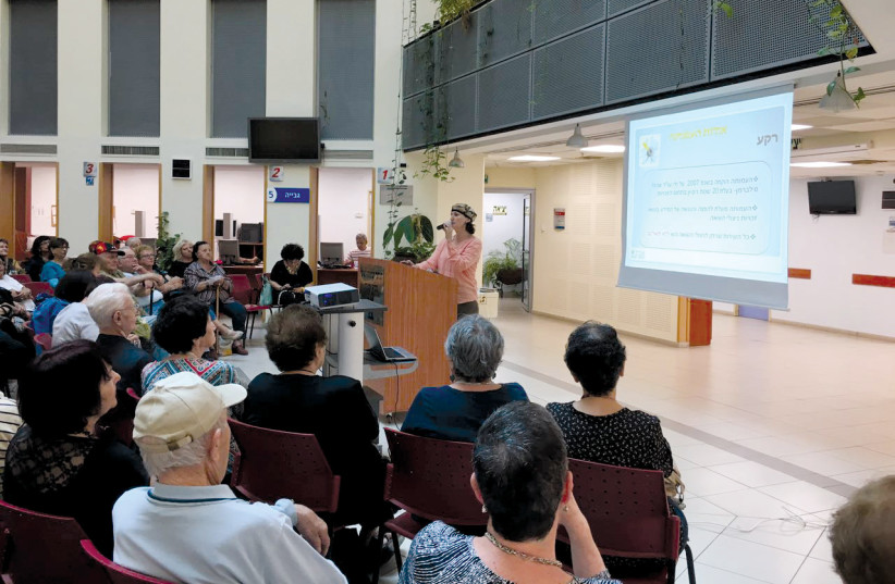  Aviva Silberman giving a lecture to National Insurance Institute volunteers on survivors’ rights in Netanya. (credit: AVIV FOR HOLOCAUST SURVIVORS)