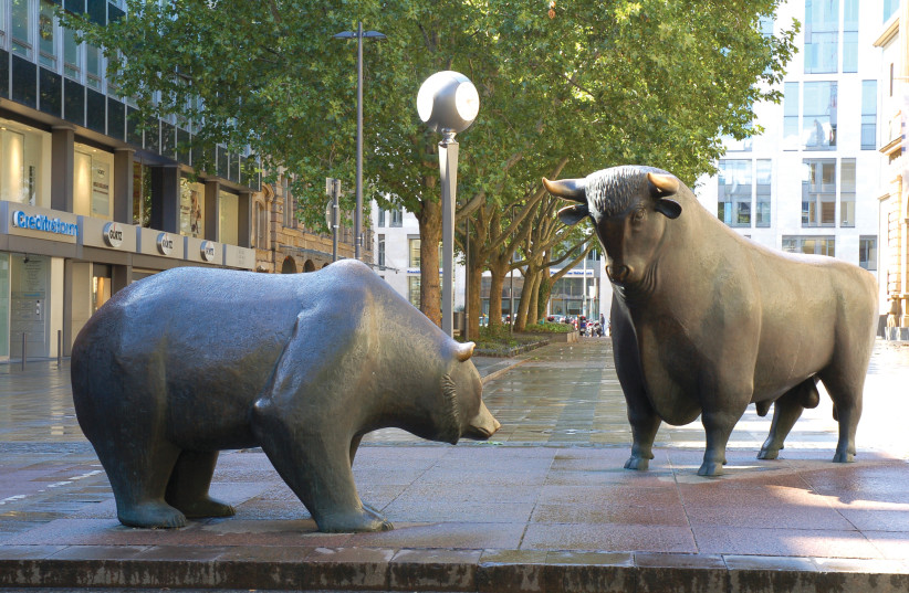  Statues of the two symbolic beasts of finance, the bear and the bull, in front of the Frankfurt Stock Exchange. (credit: EVA K/WIKIPEDIA)