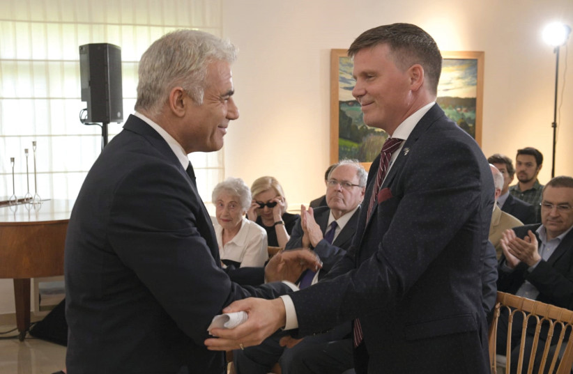  Swedish Ambassador Erik Ullenhag greets Foreign Minister Yair Lapid at a ceremony marking the 110th birthday of Raoul Wallenberg on May 31. (photo credit: FOREIGN MINISTRY)