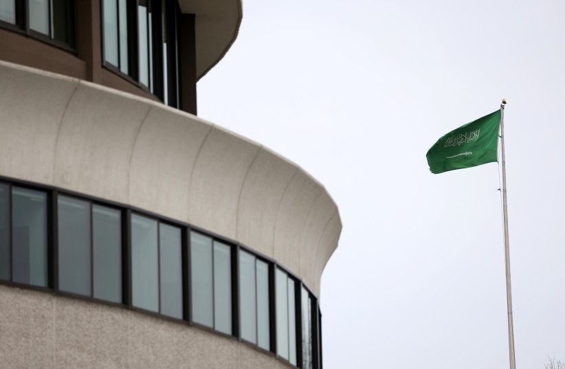  The flag of Saudi Arabia flies above the Saudi Arabia embassy near the Watergate Complex in Washington, US, February 26, 2021. (photo credit: REUTERS/TOM BRENNER)
