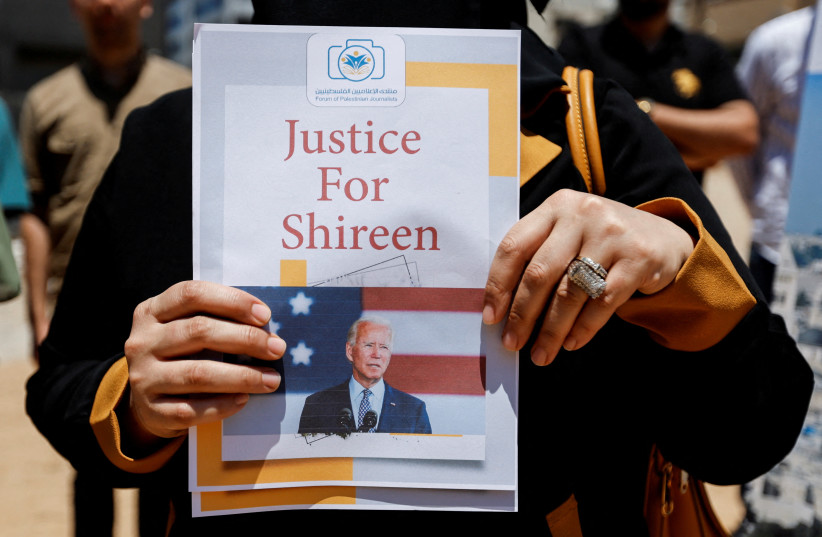  Palestinians attend a protest demanding US President Joe Biden to achieve justice for Al Jazeera journalist Shireen Abu Akleh, who was killed during an Israeli raid in Jenin, in Gaza City July 13, 2022 (photo credit: REUTERS/IBRAHEEM ABU MUSTAFA)