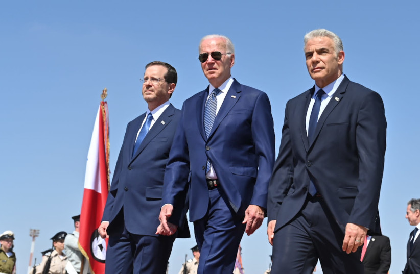 Prime Minister Yair Lapid and President Yair Lapid accompany US President Joe Biden shortly after his landing  on July 13, 2022 (photo credit: KOBI GIDEON/GPO)