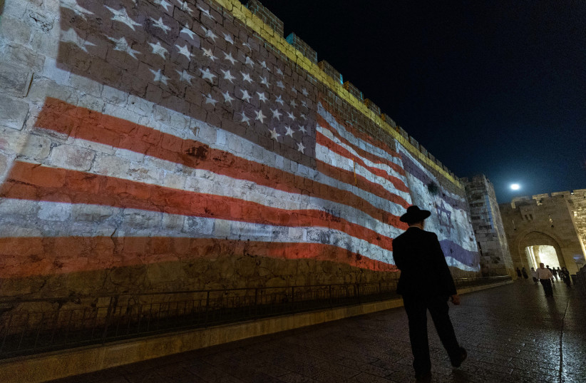 The US and Israeli flags are screened on the walls of Jerusalem's Old City as a welcoming to US president Joe Biden , on July 13, 2022 (photo credit: YONATAN SINDEL/FLASH 90)