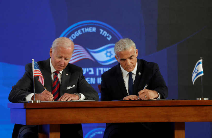 US President Joe Biden and Israeli Prime Minister Yair Lapid sign a security pledge at Waldorf Astoria Hotel in Jerusalem, Israel July 14, 2022 (credit: EVELYN HOCKSTEIN/REUTERS)