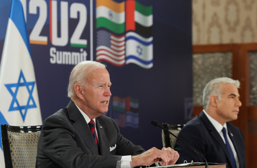 US President Joe Biden and Israeli Prime Minister Yair Lapid attend the first virtual meeting of the "I2U2" group with leaders of India and the United Arab Emirates, in Jerusalem, July 14, 2022 (photo credit: EVELYN HOCKSTEIN/REUTERS)