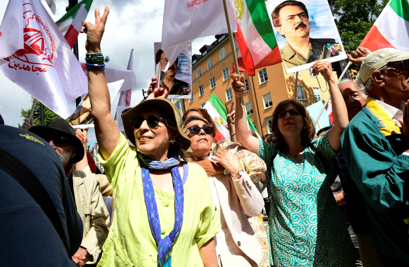 People react to the verdict of the trial of Hamid Noury, a former Iranian prosecution official accused of crimes against international law and murder in Iran in 1988, outside the Stockholm District Court in Stockholm, Sweden July 14, 2022 (photo credit: CHRIS ANDERSON/TT NEWS AGENCY/VIA REUTERS)