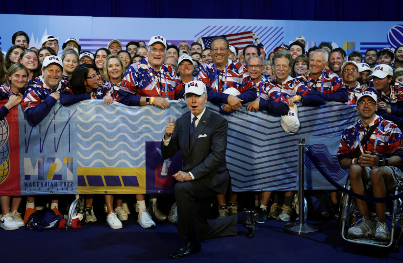  US President Joe Biden poses with the US athletes at Teddy Stadium, in Jerusalem, July 14, 2022 (photo credit: REUTERS/EVELYN HOCKSTEIN)