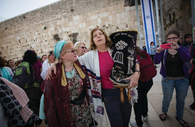  ANAT HOFFMAN holds a Torah scroll at a Western Wall prayer service on the occasion of Rosh Hodesh. The very people who have turned the Kotel into a battleground are now crying foul, says the writer. (credit: MIRIAM ALSTER/FLASH90)