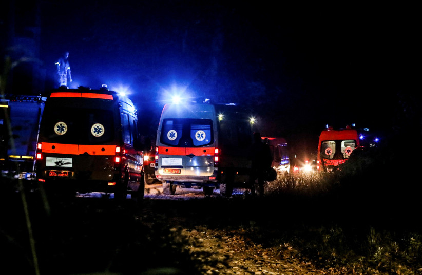  Ambulances are seen at the crash site of an Antonov An-12 cargo plane owned by a Ukrainian company, near Kavala, Greece, July 16, 2022. (credit: LASKARIS TSOTSAS/EUROKINISSI VIA REUTERS)
