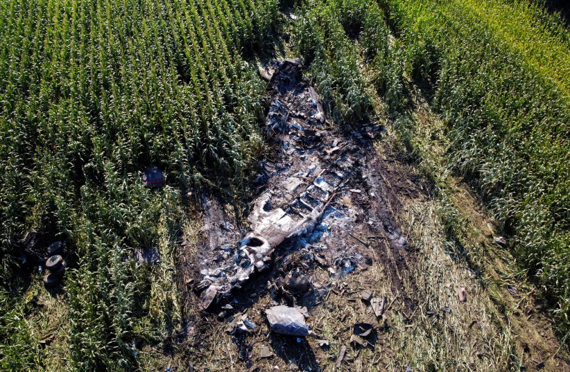 Debris is seen at the crash site of an Antonov An-12 cargo plane owned by a Ukrainian company, near Kavala, Greece, July 17, 2022. (photo credit: REUTERS/ALKIS KONSTANTINIDIS)