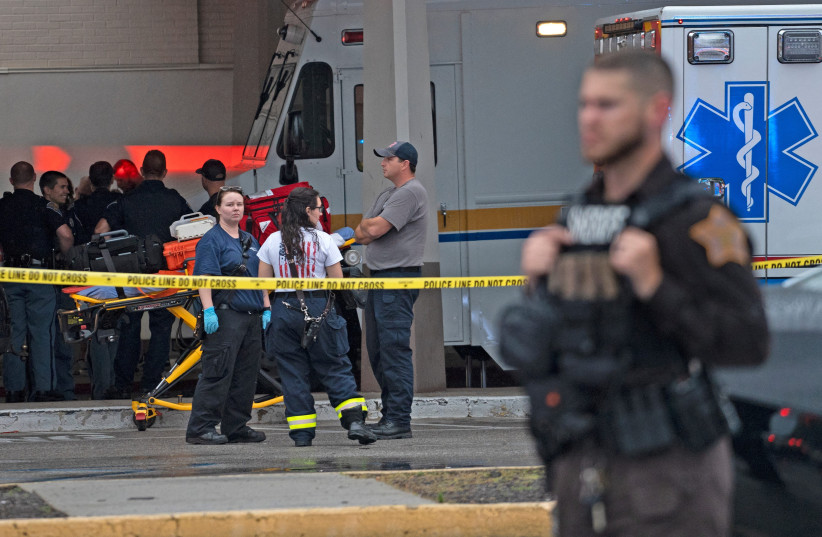 Emergency personnel gather after a shooting at Greenwood Park Mall in Greenwood, Indiana, US, July 17, 2022. (photo credit: KELLY WILKINSON/USA TODAY NETWORK VIA REUTERS)