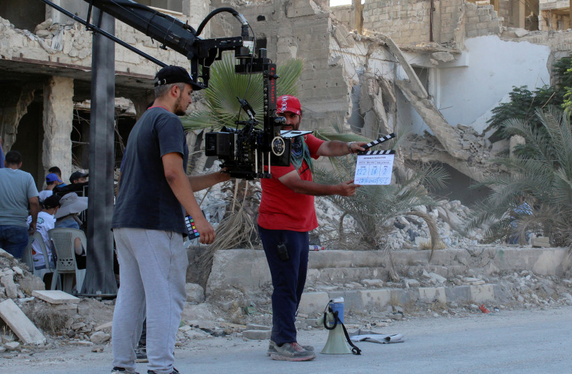  Crew members work on the movie set of a Jackie Chan-produced film 'Home Operation', in Hajar al-Aswad, an area on the southern outskirts of Damascus that was heavily damaged during Syria's civil war, Syria July 17, 2022.  (photo credit: REUTERS/FIRAS MAKDESI)