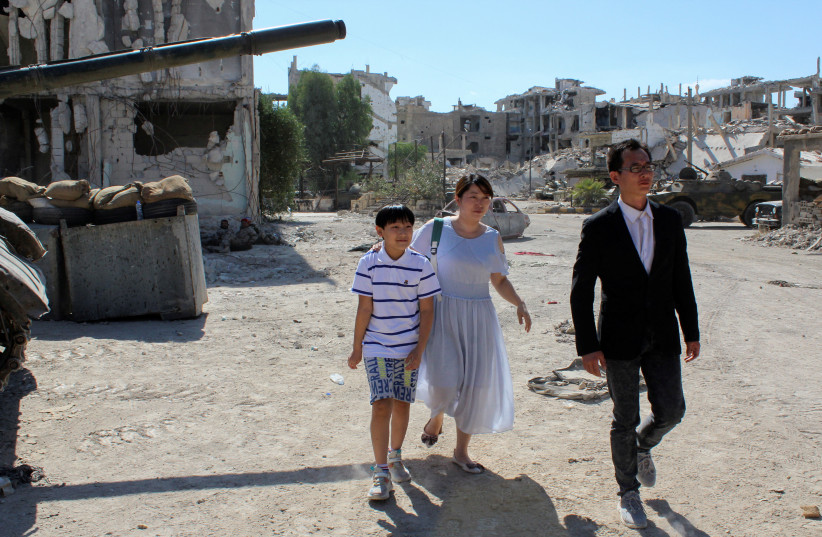  Chinese actors walk on the movie set of a Jackie Chan-produced film 'Home Operation', in Hajar al-Aswad, an area on the southern outskirts of Damascus that was heavily damaged during Syria's civil war, Syria July 17, 2022. (credit: REUTERS/FIRAS MAKDESI)