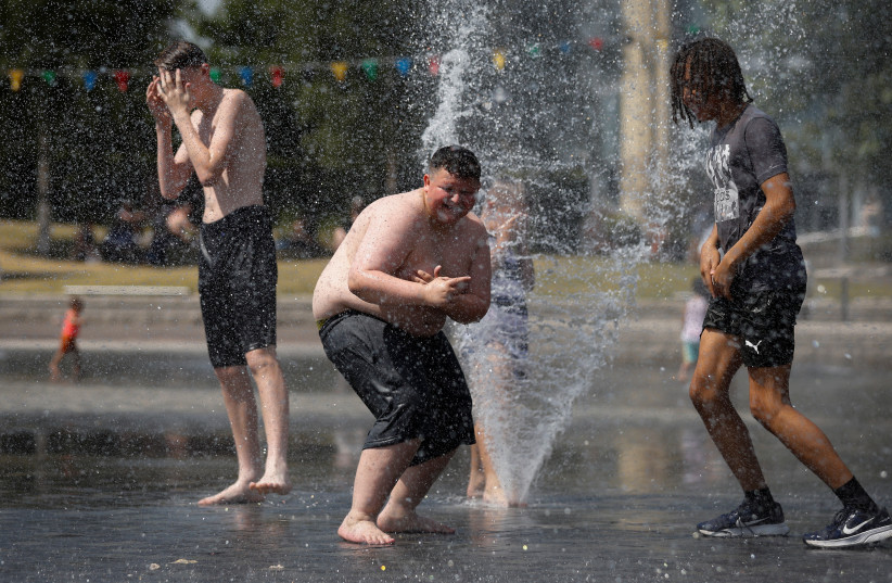  Children play during the continuing hot weather among the water fountains in Centenary Square, Bradford, Britain, July 19, 2022. (credit: REUTERS)